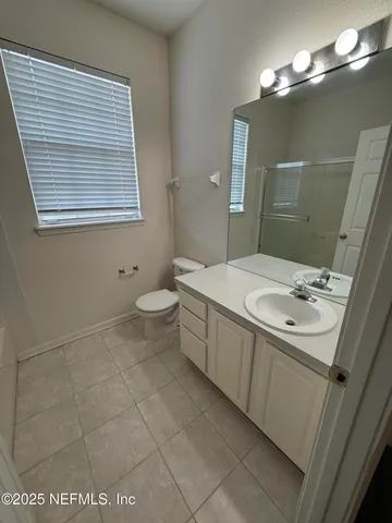 a bathroom with a sink a toilet and mirror