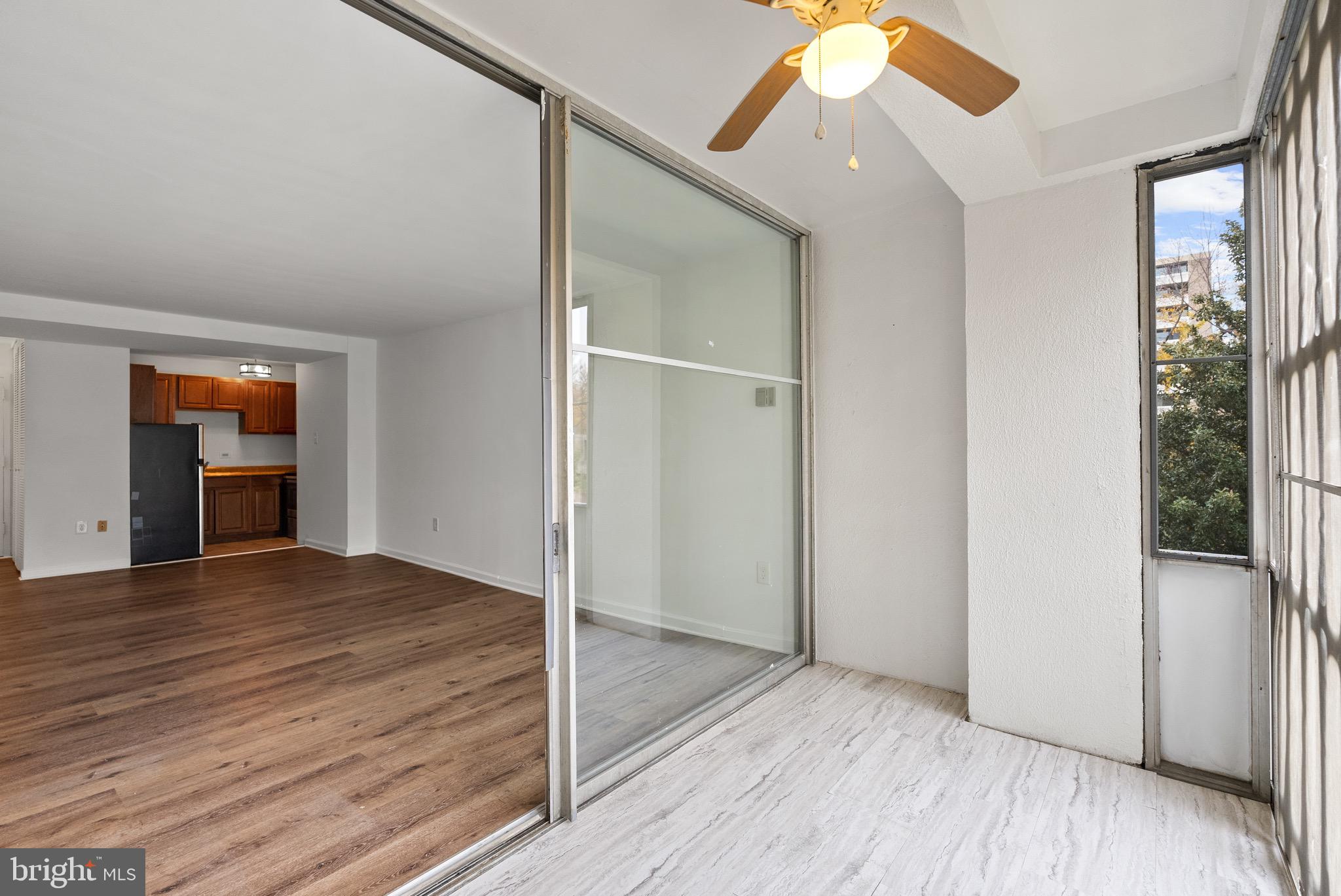 1301 Delaware Avenue Southwest, Unit N108 Washington, DC 20024 - Photo 16 of 39 a view of an empty room with wooden floor and a window
