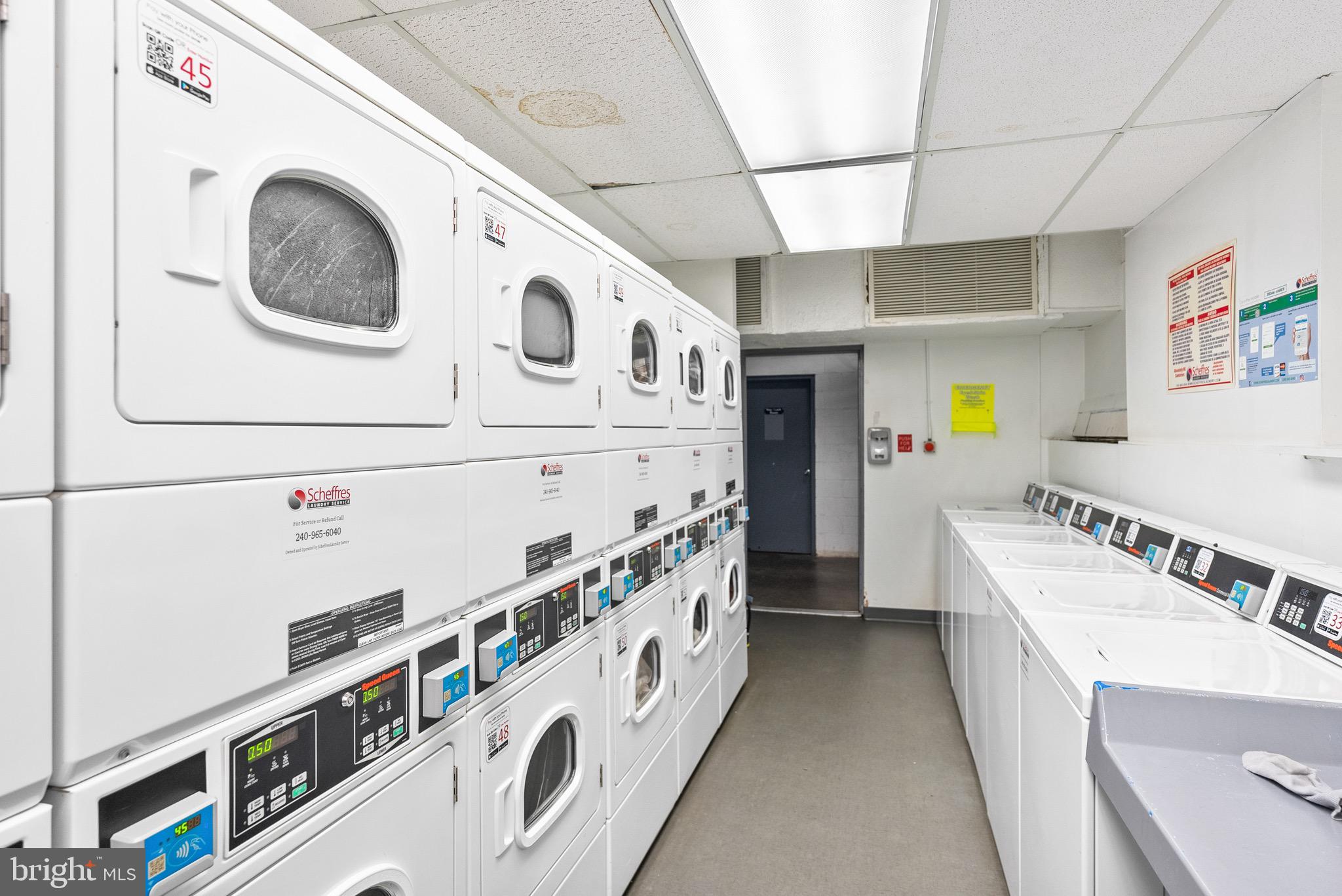 1301 Delaware Avenue Southwest, Unit N108 Washington, DC 20024 - Photo 33 of 39 a bathroom with stainless steel appliances a sink a stove and a refrigerator