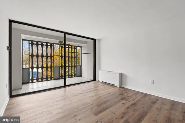 a view of an empty room with wooden floor