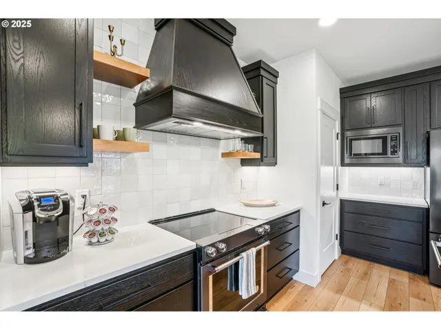 a kitchen with stainless steel appliances granite countertop a sink and a stove
