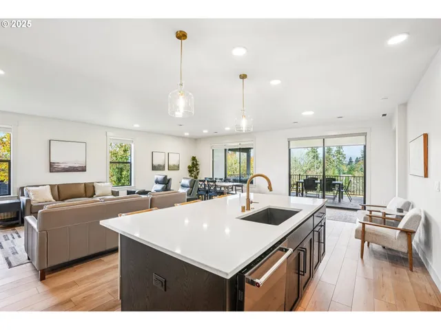 a kitchen with a sink a counter space and living room