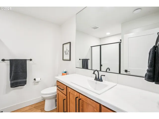a bathroom with a sink toilet a mirror and shower