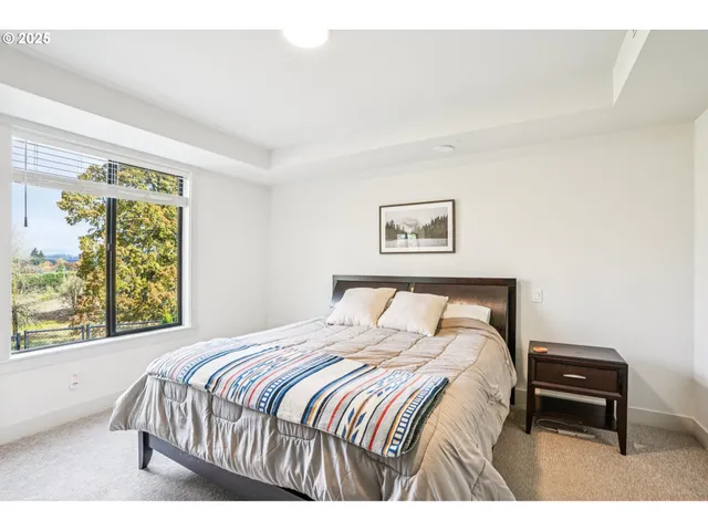 a bedroom with a bed a table and a window