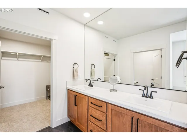 a bathroom with a sink double vanity and a mirror