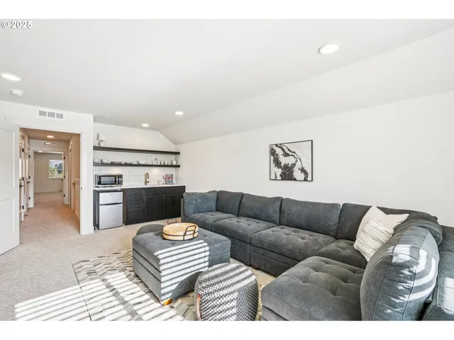 a living room with furniture and kitchen view