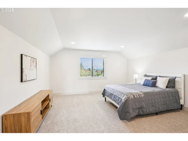 a bedroom with a bed and a lamp