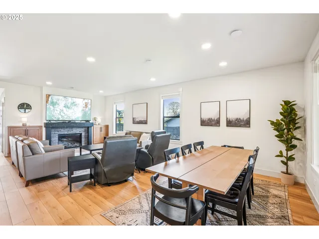 a living room with furniture a dining table and a potted plant