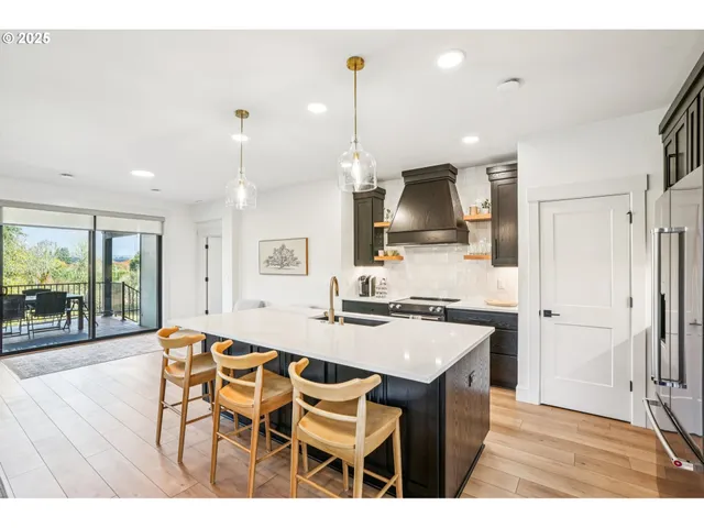 a kitchen with stainless steel appliances kitchen island granite countertop a sink and cabinets