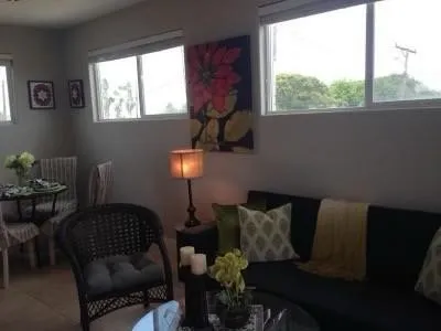 a living room with furniture lamp and window
