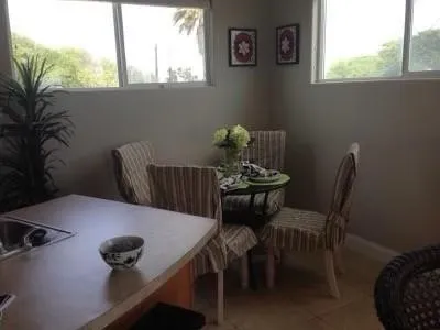 a view of a dining room with furniture and window