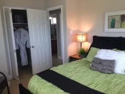 a bedroom with a bed and a painting on the wall