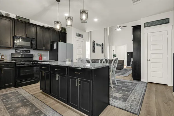 a kitchen with stainless steel appliances a sink stove and refrigerator