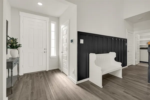 a view of a hallway with wooden floor and staircase