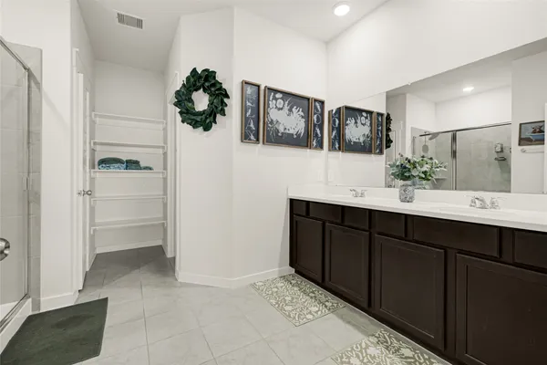 a bathroom with a double vanity sink and mirror