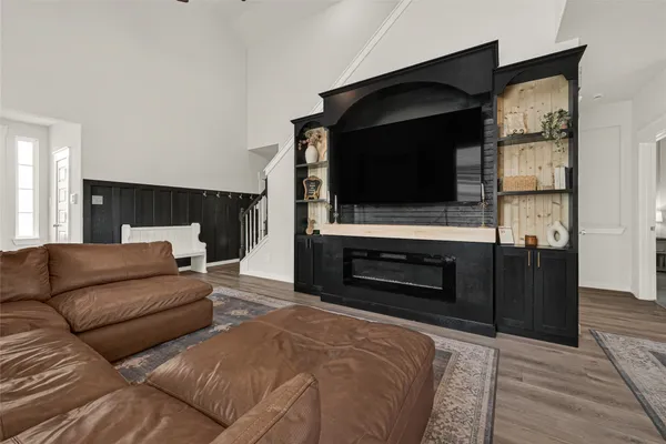 a living room with a flat screen tv and a fireplace