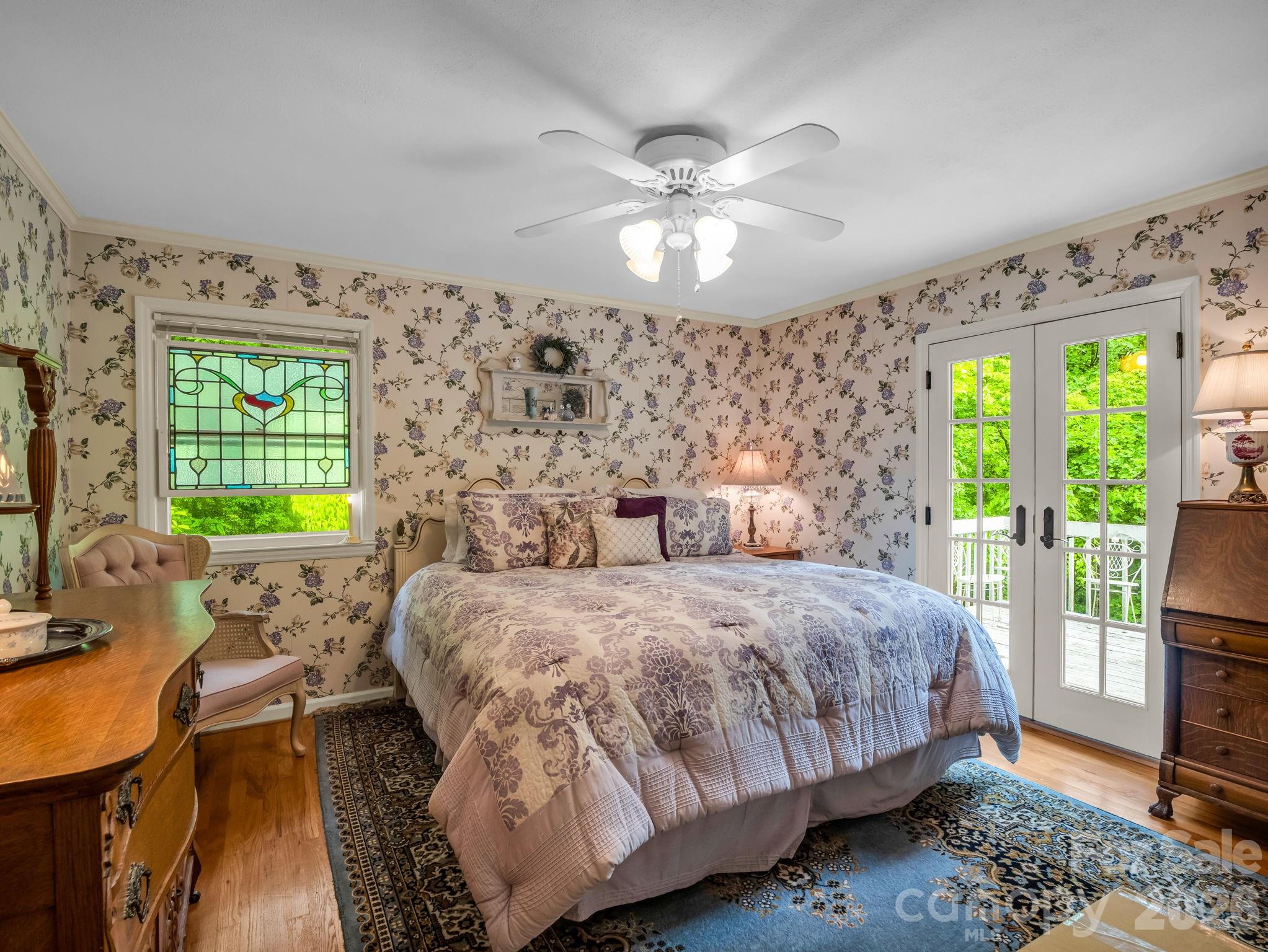 57 Tate Lane Tryon, NC 28782 - Photo 18 of 48 a bedroom with a bed and a chandelier
