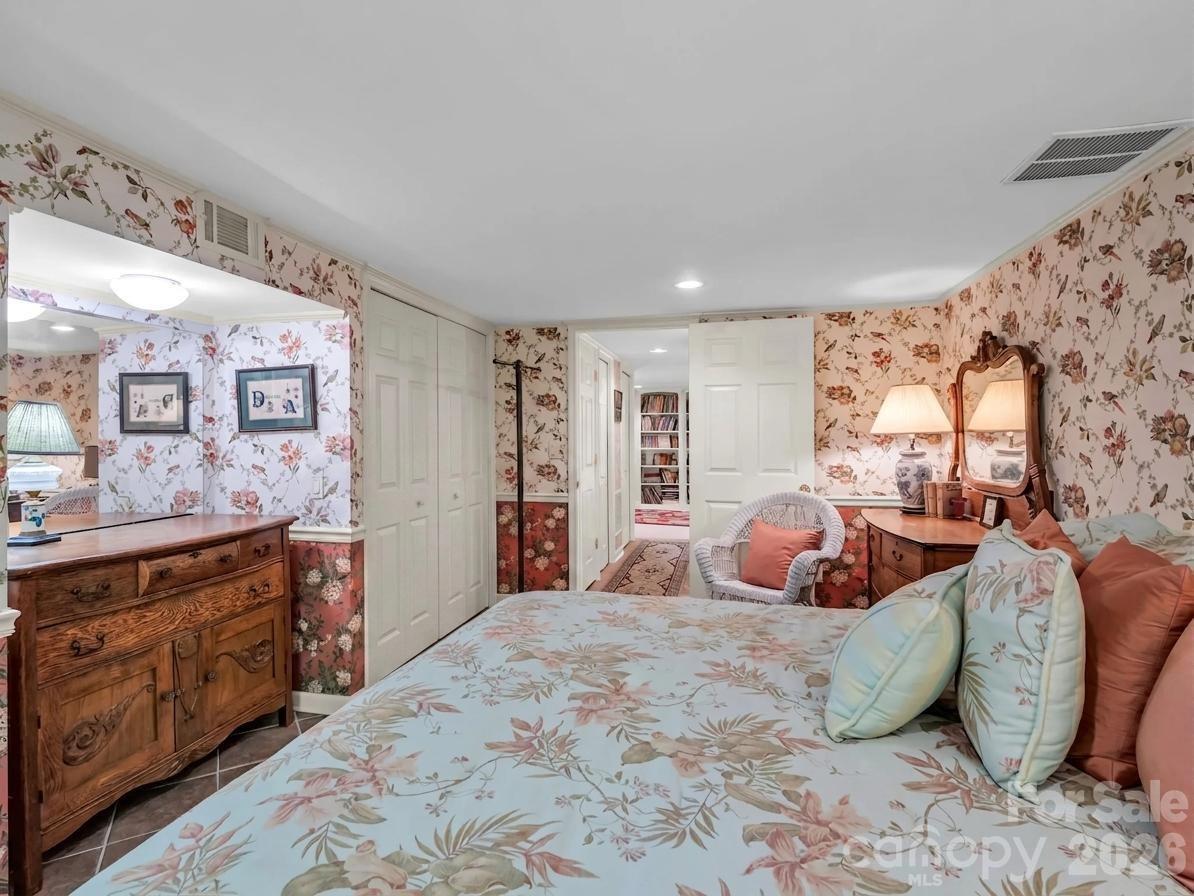 57 Tate Lane Tryon, NC 28782 - Photo 37 of 48 a bedroom with a bed and wooden floor