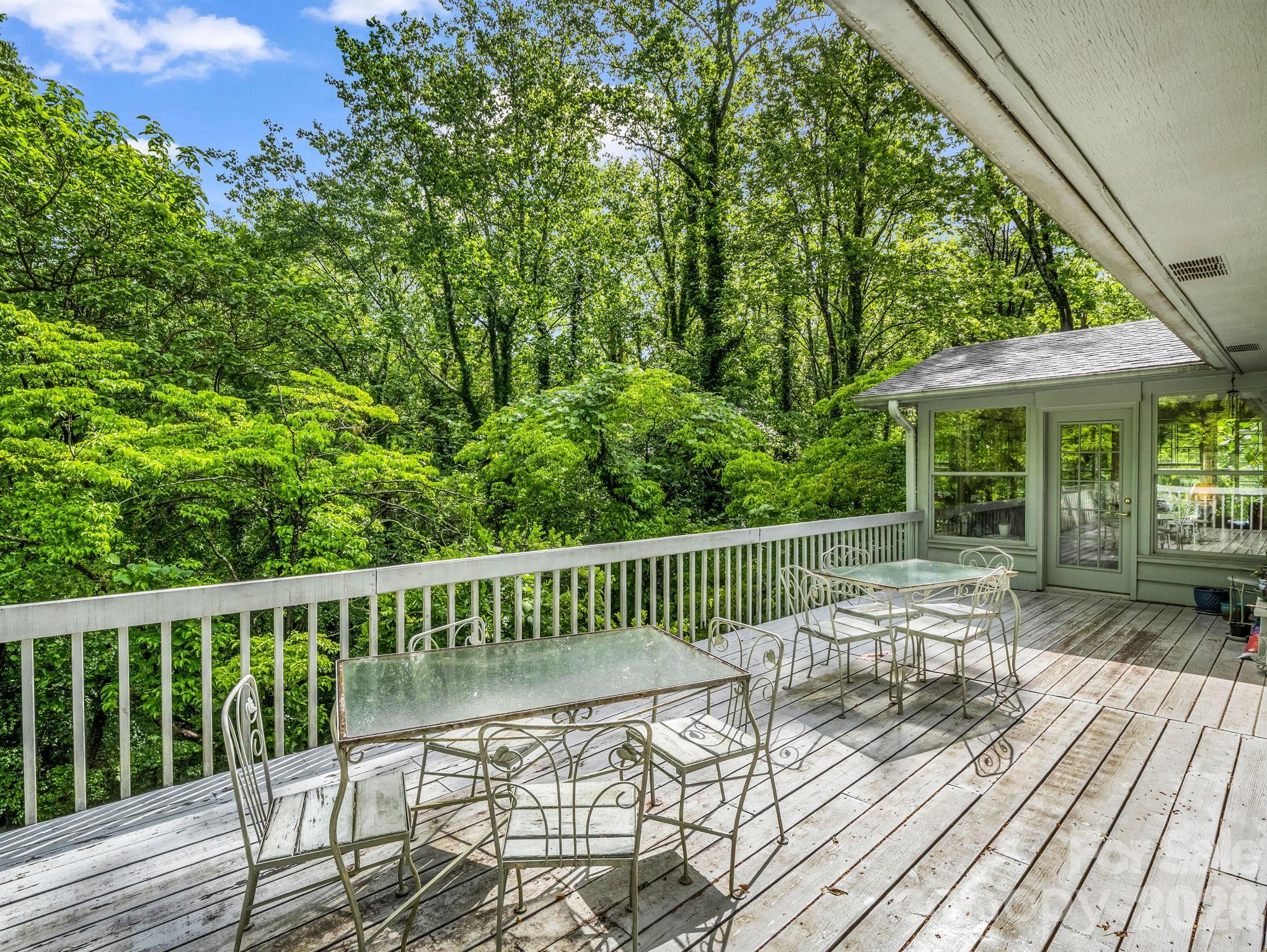 57 Tate Lane Tryon, NC 28782 - Photo 43 of 48 a view of a chair and tables under an umbrella
