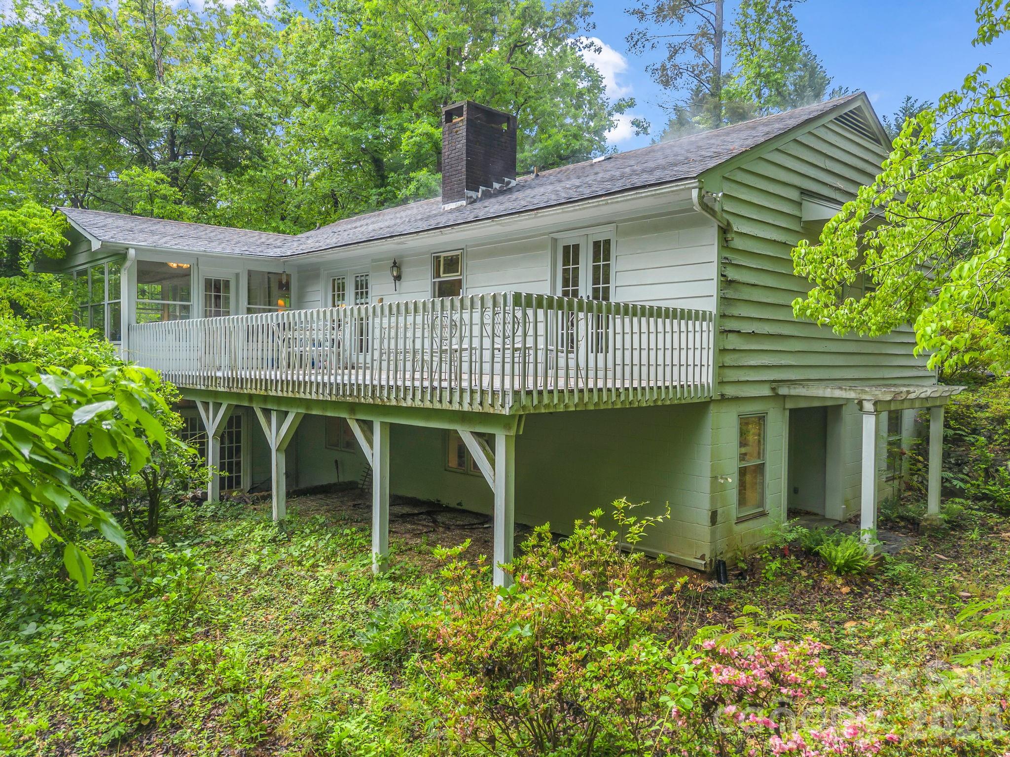 57 Tate Lane Tryon, NC 28782 - Photo 44 of 48 a front view of a house with a garden