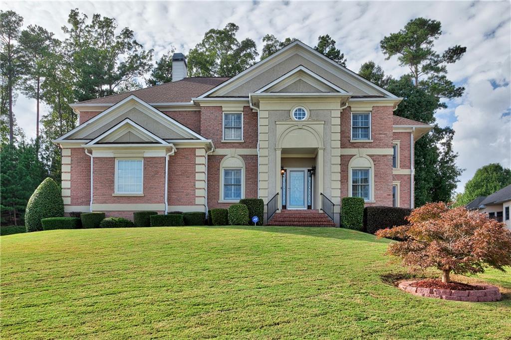 a front view of a house with a yard