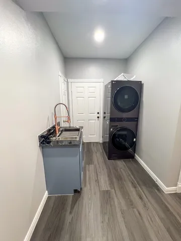 a living room with a couch and a stove with wooden floor