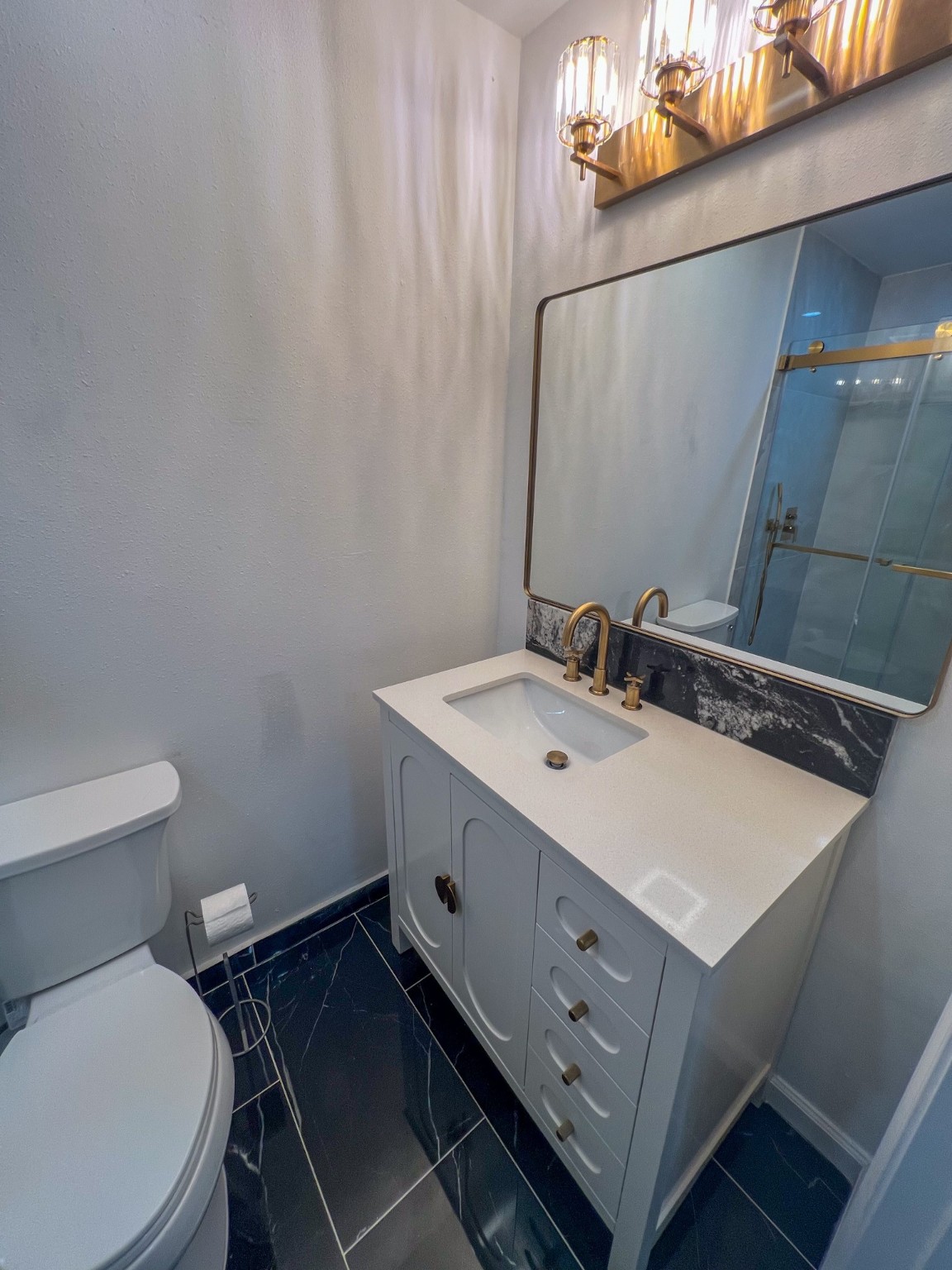 4605 Orange Street Houston, TX 77020 - Photo 19 of 28 a bathroom with a sink mirror vanity and toilet