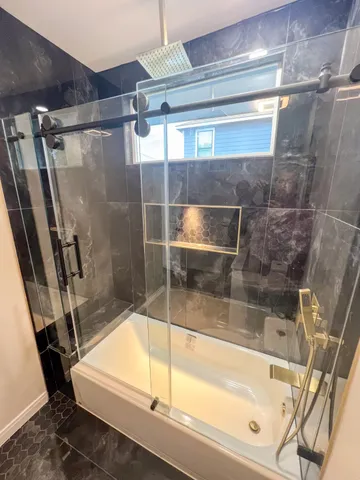 a bathroom with a bathtub and a shower