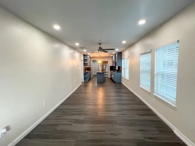 a view of a hall with wooden floor