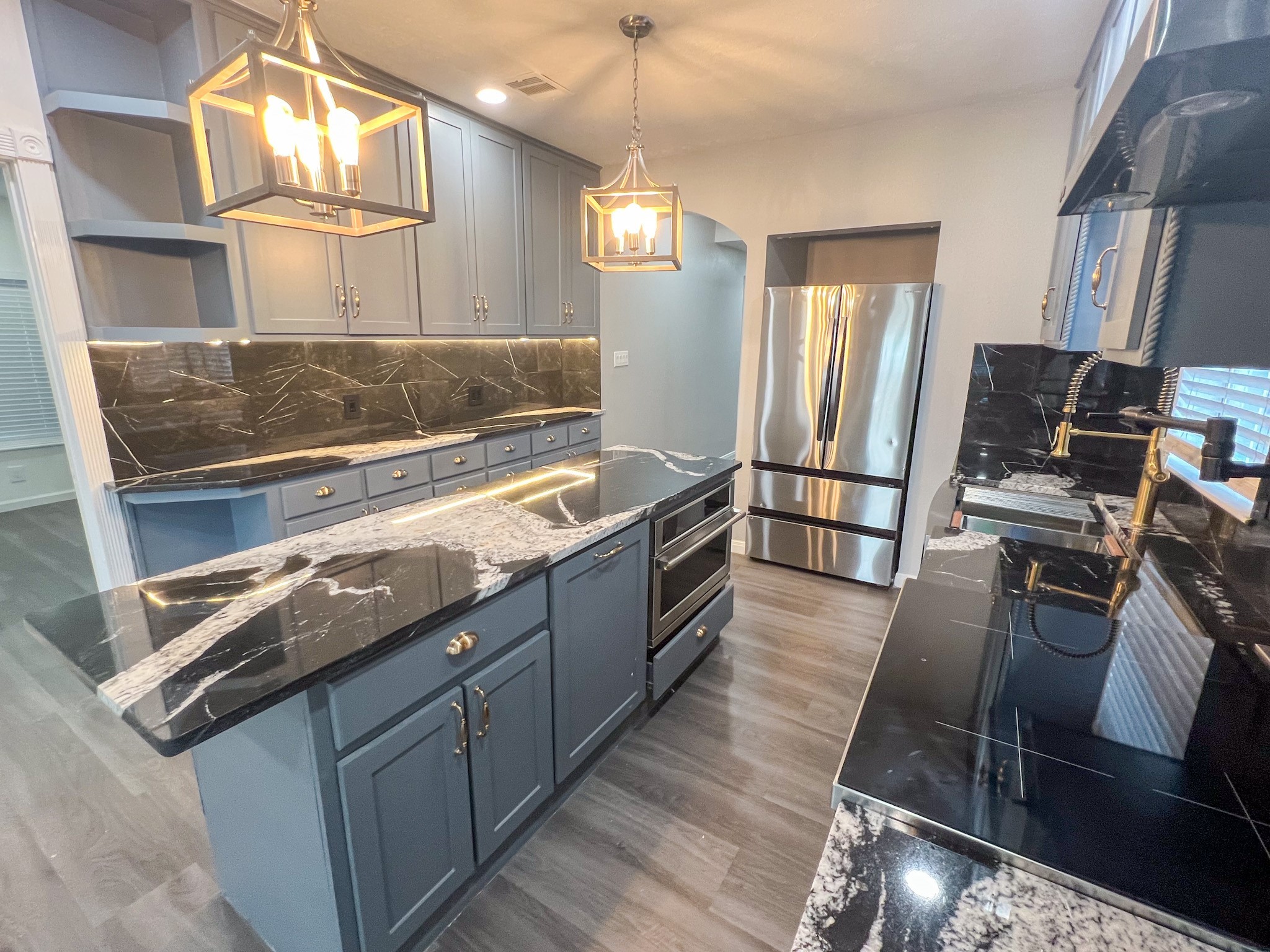 4605 Orange Street Houston, TX 77020 - Photo 25 of 28 a kitchen with kitchen island granite countertop a stove refrigerator and microwave