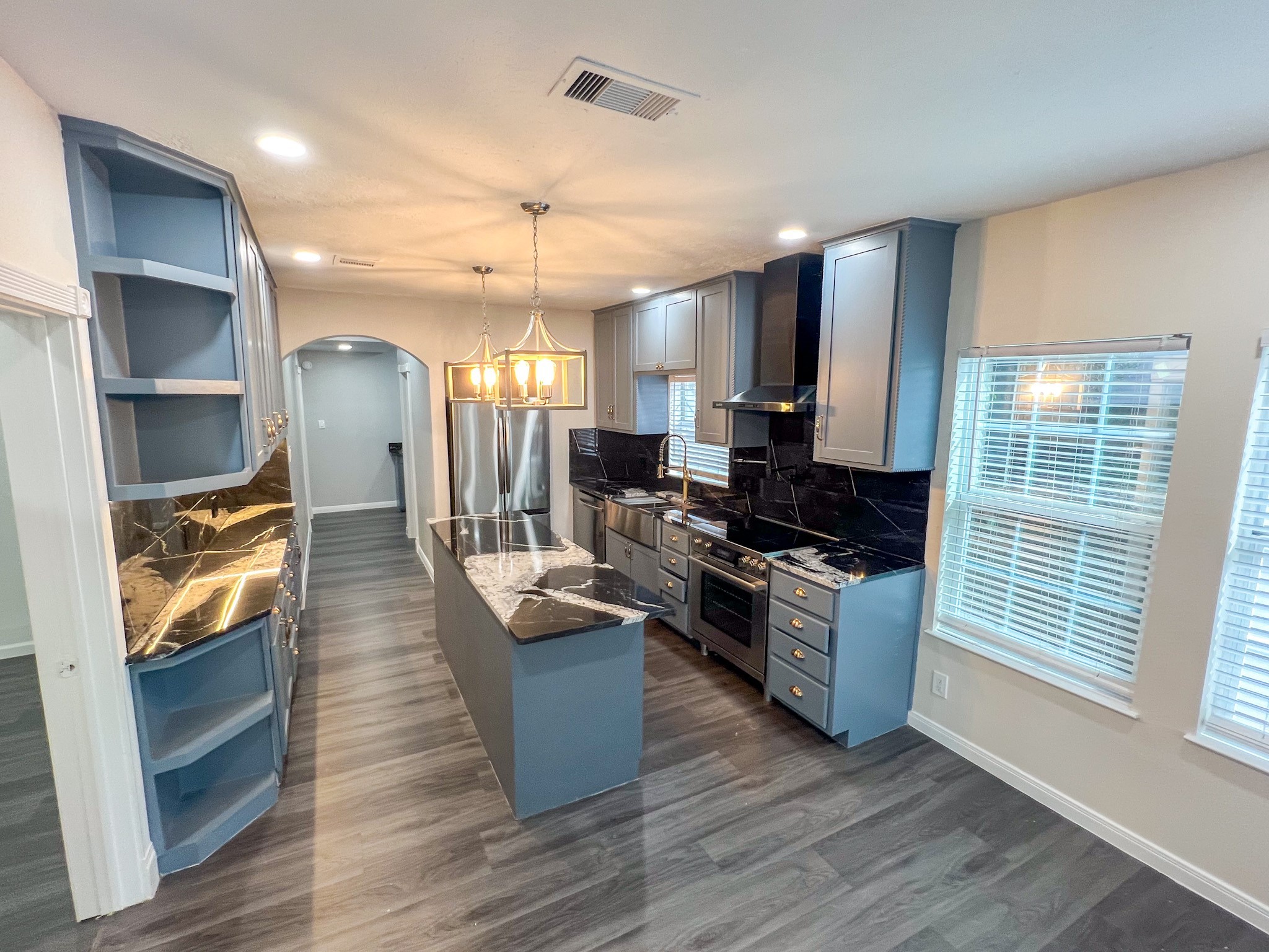 4605 Orange Street Houston, TX 77020 - Photo 26 of 28 a large kitchen with stainless steel appliances granite countertop a stove and a wooden floors