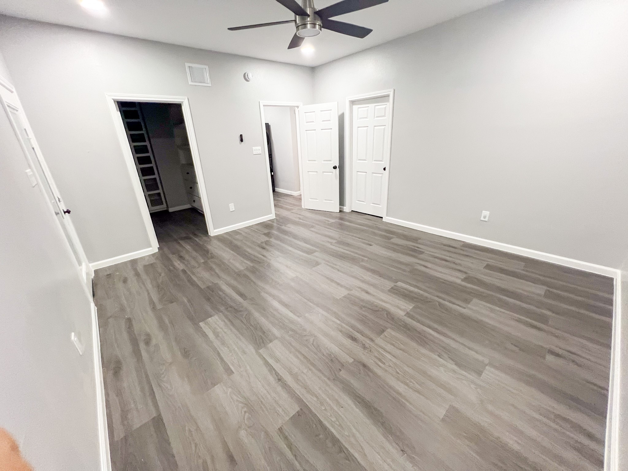 4605 Orange Street Houston, TX 77020 - Photo 9 of 28 an empty room with wooden floor and a ceiling fan