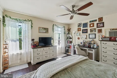 a bed room with a bed and a television