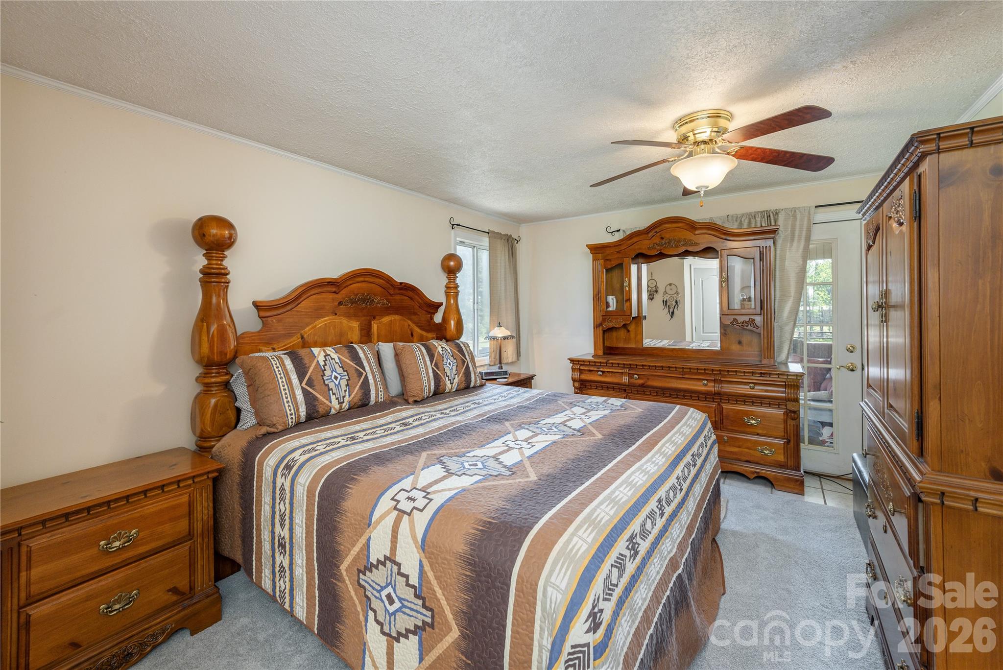 231 Allen Road East Flat Rock, NC 28726 - Photo 18 of 42 a bedroom with a bed and a chandelier
