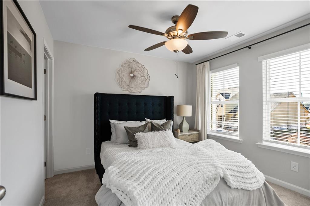 1150 Hunter Trail, Unit ELDERFLOWER Acworth, GA 30102 - Photo 20 of 30 a bedroom with a large bed and a large window