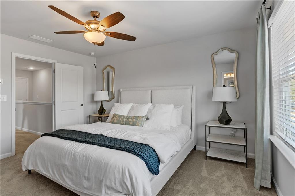 1150 Hunter Trail, Unit ELDERFLOWER Acworth, GA 30102 - Photo 25 of 30 a bedroom with a bed and a lamp on the dresser