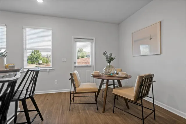 a view of a dining room with furniture window and wooden floor