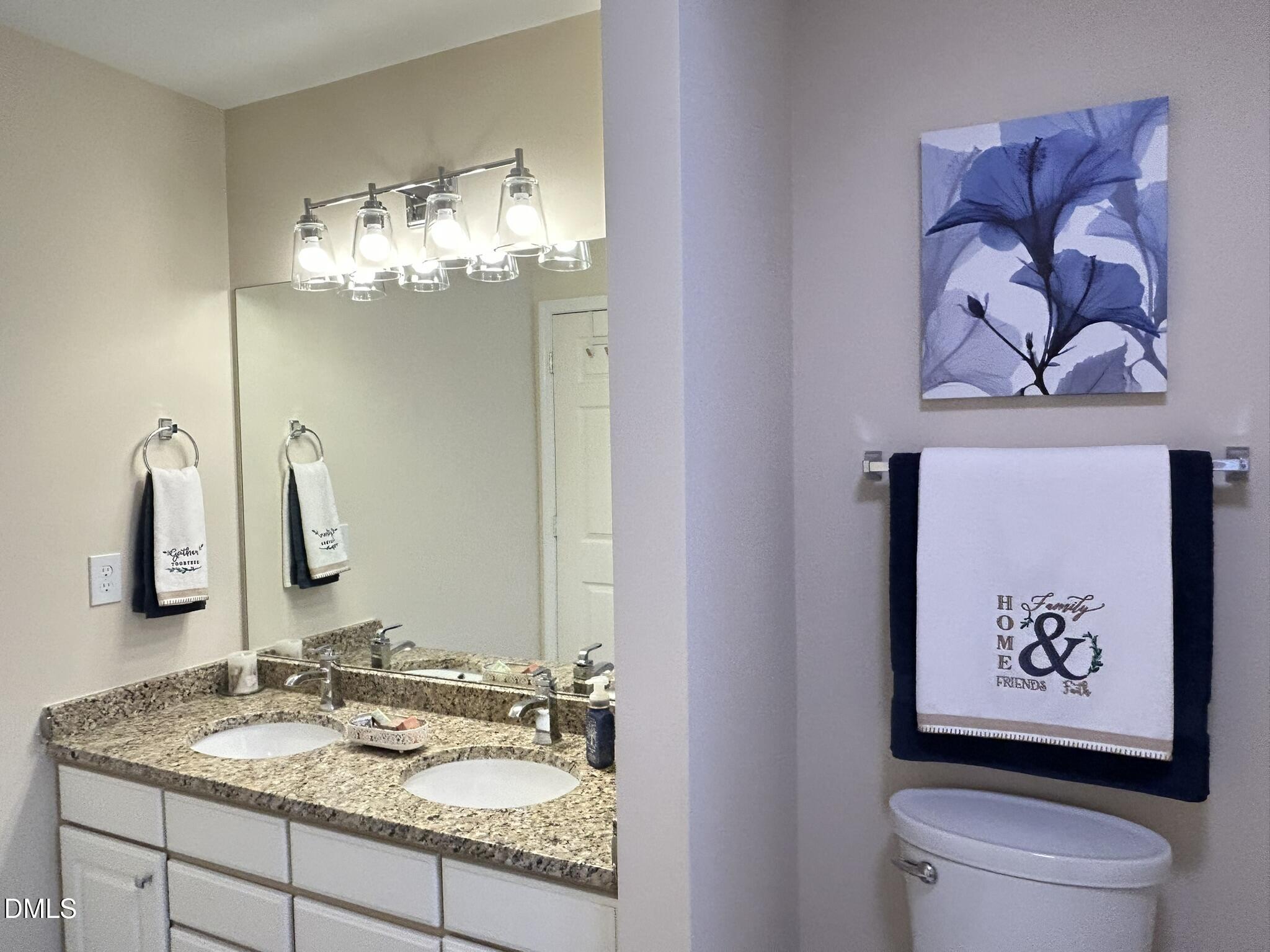 2510 Friedland Place, Unit 102 Raleigh, NC 27617 - Photo 37 of 42 a bathroom with a granite countertop sink and a mirror