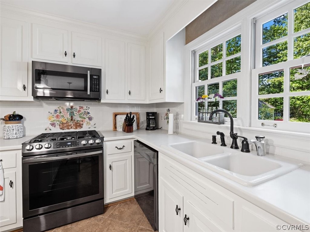 2310 Dorking Road North Chesterfield, VA 23236 - Photo 12 of 44 a kitchen with stainless steel appliances granite countertop a sink a stove and a microwave