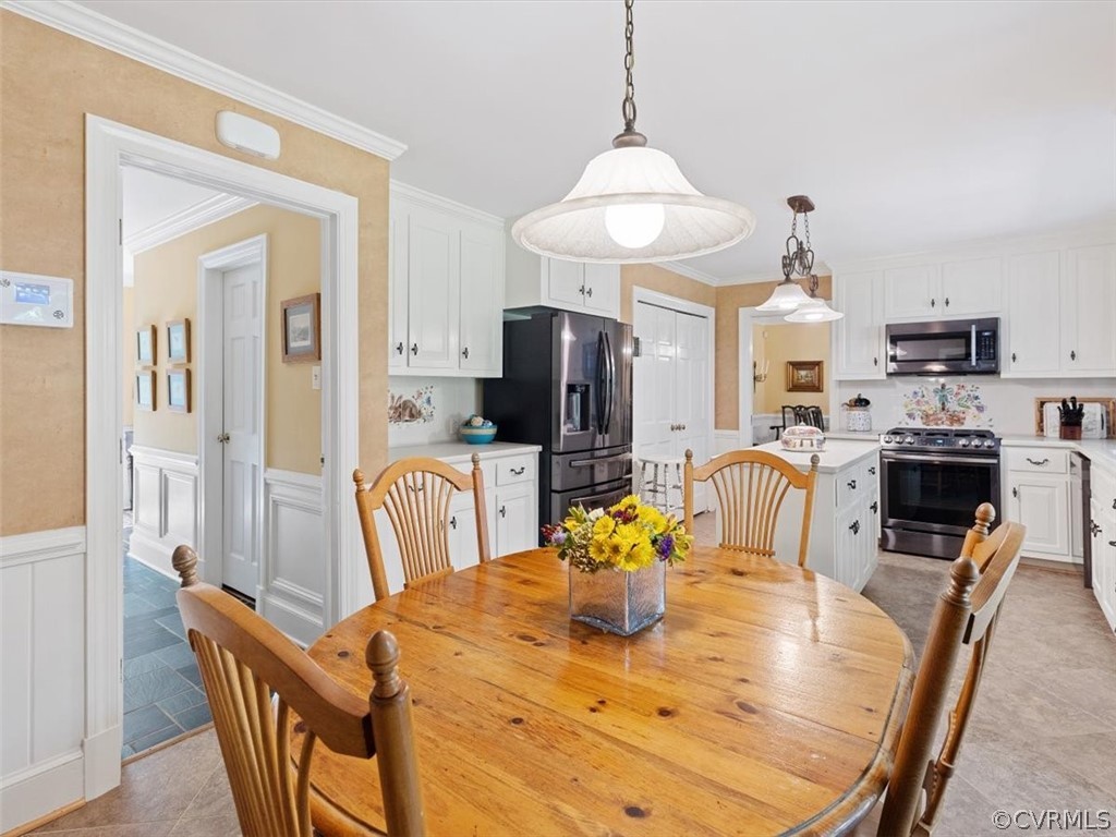 2310 Dorking Road North Chesterfield, VA 23236 - Photo 13 of 44 a dining room with furniture a chandelier and wooden floor