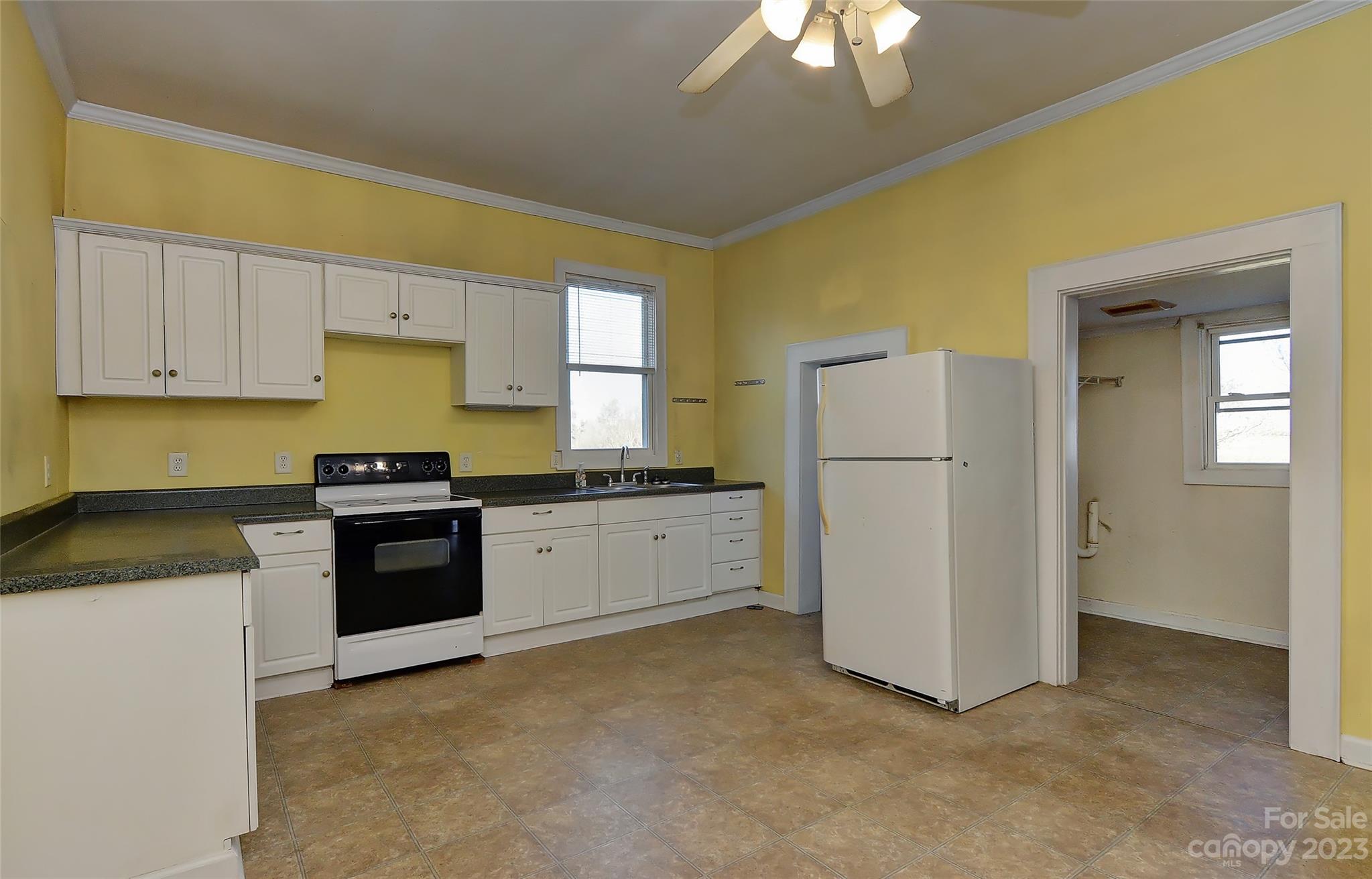 6202 White Store Pageland Road Marshville, NC 28103 - Photo 14 of 22 a kitchen with a refrigerator and a stove top oven