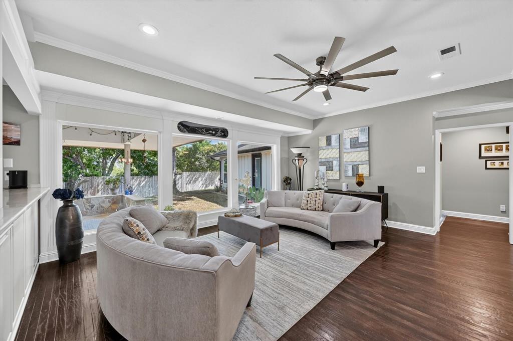 47 Bounty Road East Benbrook, TX 76132 - Photo 3 of 39 Spacious living area featuring large windows, dark wood-finish flooring, recessed lighting, and a modern ceiling fan