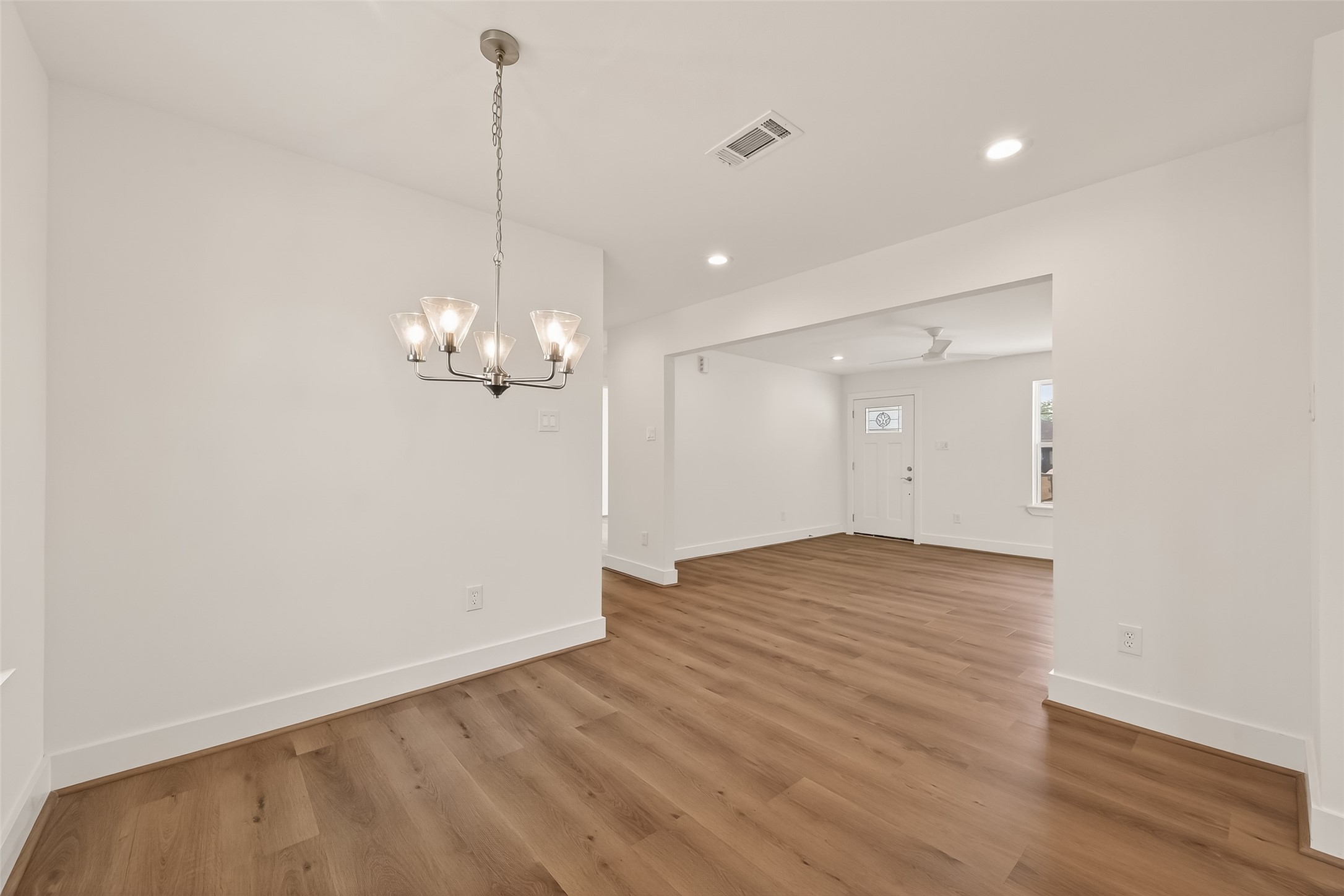 2723 Castledale Drive Houston, TX 77093 - Photo 11 of 38 a view of a chandelier fan and wooden floor