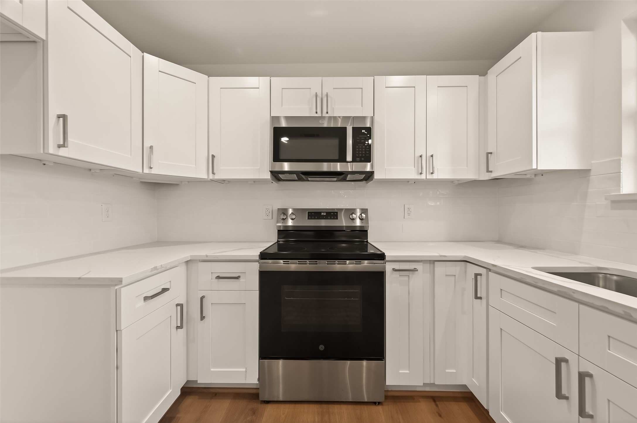 2723 Castledale Drive Houston, TX 77093 - Photo 15 of 38 a kitchen with white cabinets and black appliances