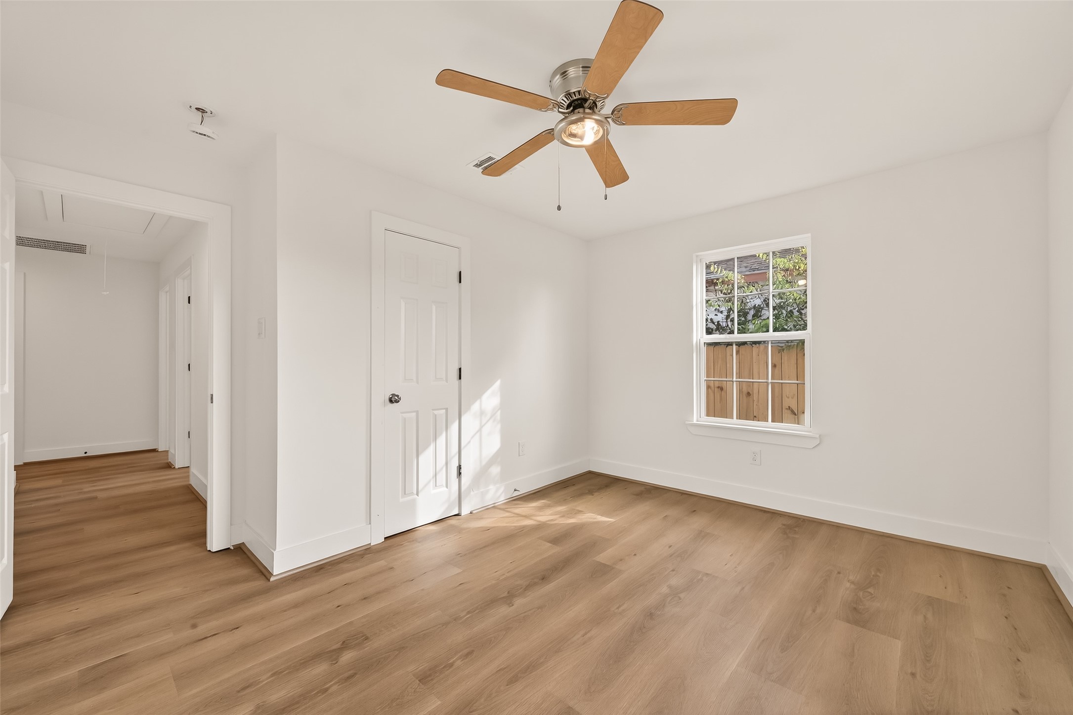 2723 Castledale Drive Houston, TX 77093 - Photo 22 of 38 an empty room with wooden floor fan and windows