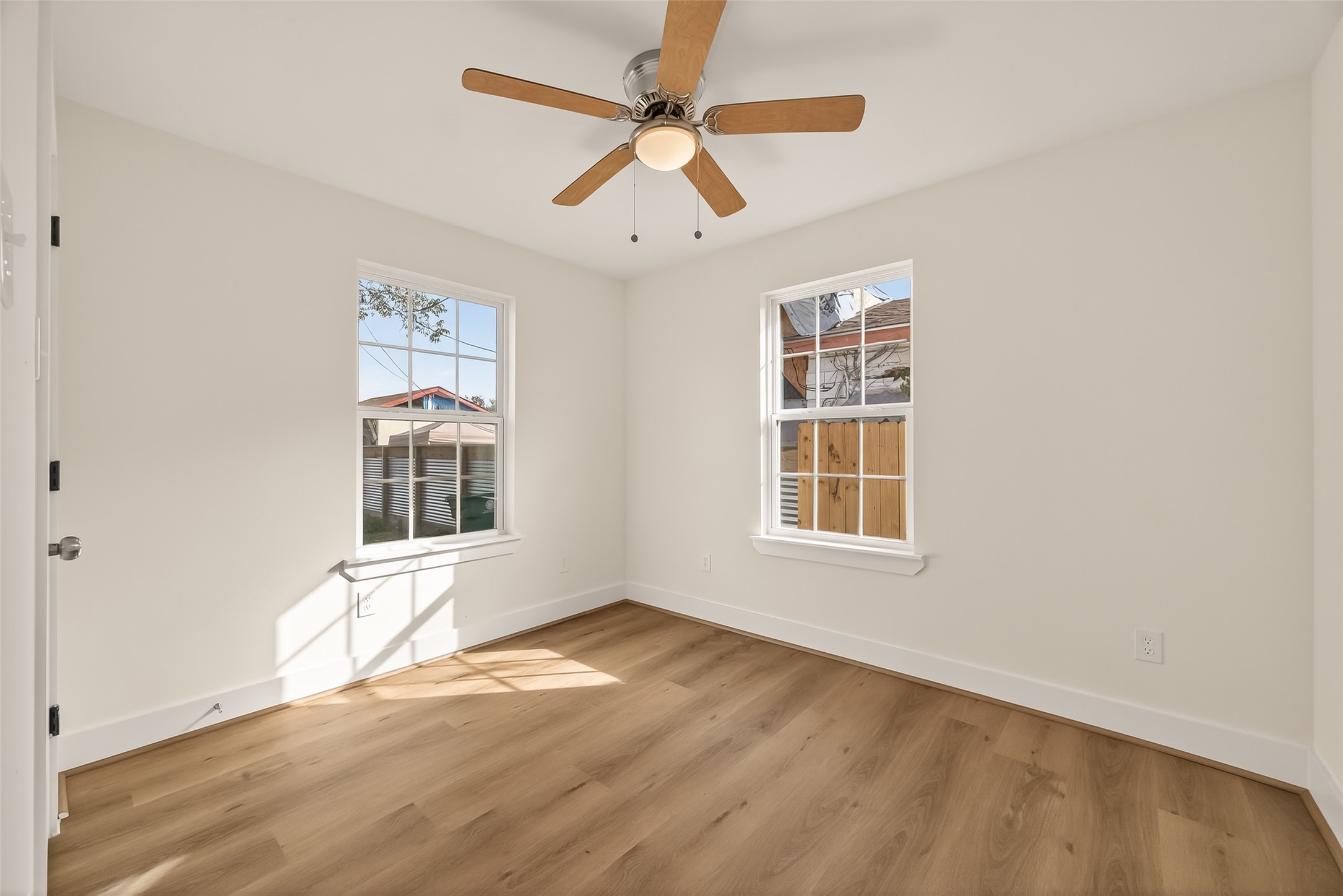 2723 Castledale Drive Houston, TX 77093 - Photo 26 of 38 an empty room with wooden floor chandelier fan and windows
