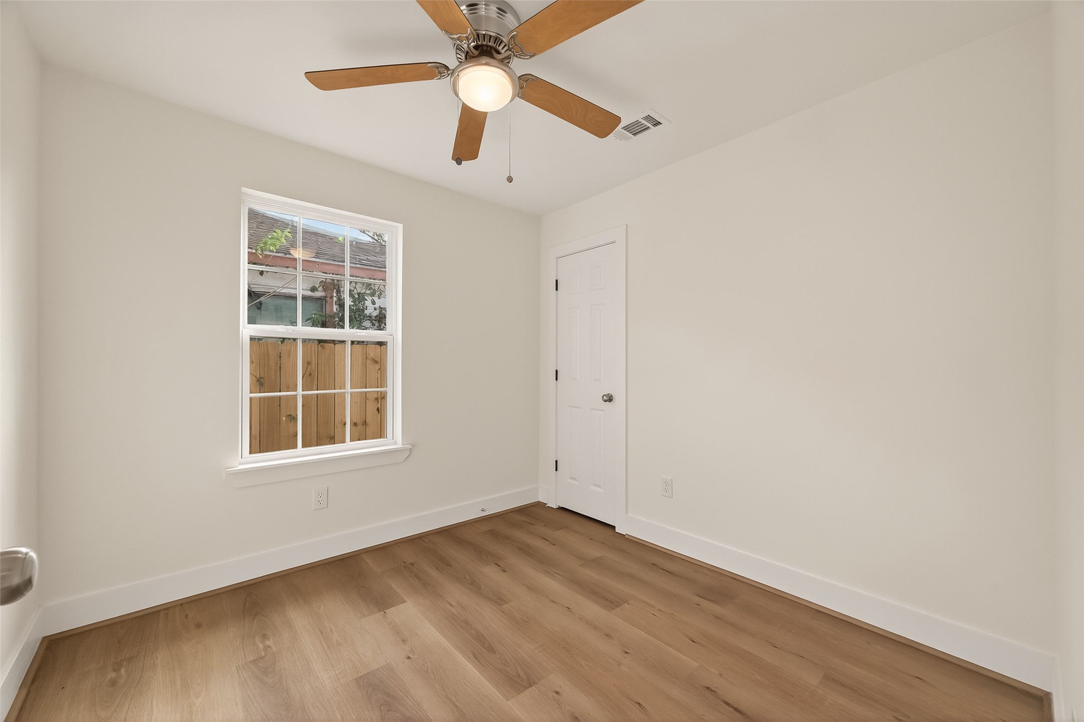 2723 Castledale Drive Houston, TX 77093 - Photo 28 of 38 an empty room with a window and a fan