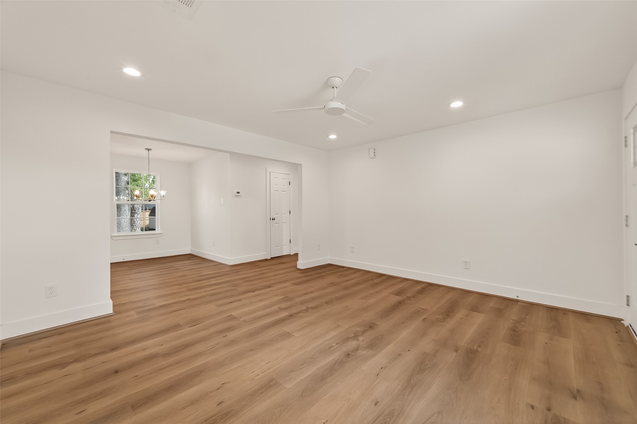 2723 Castledale Drive Houston, TX 77093 - Photo 7 of 38 an empty room with wooden floor and windows