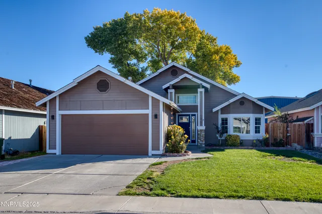 a front view of a house with a garden and plants