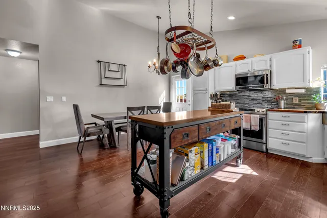 a kitchen with stainless steel appliances granite countertop a stove and cabinets